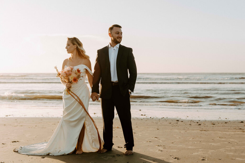 couple standing by ocean for elopement photos