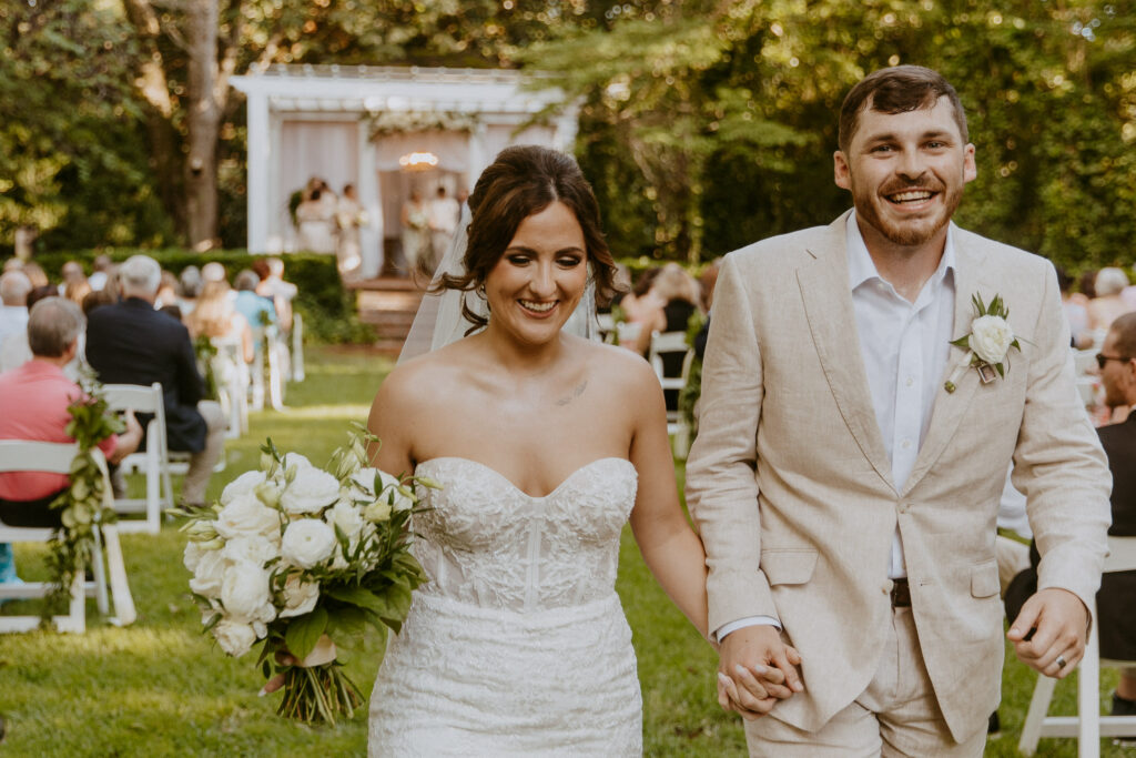 bride and groom holding hands during wedding ceremony of southern charm wedding day