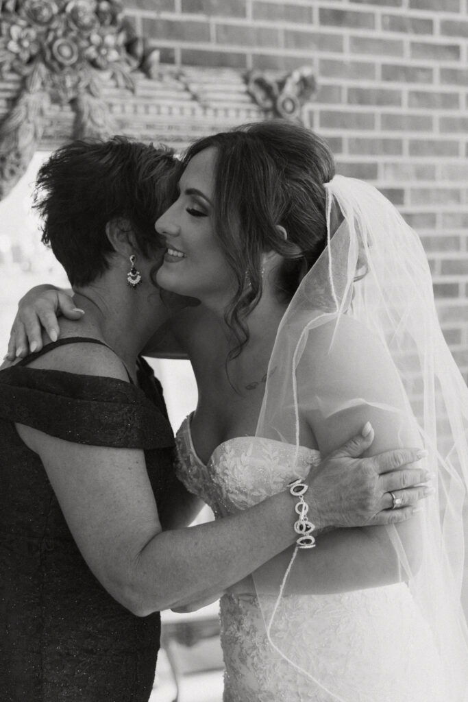 bride hugging mom after getting ready