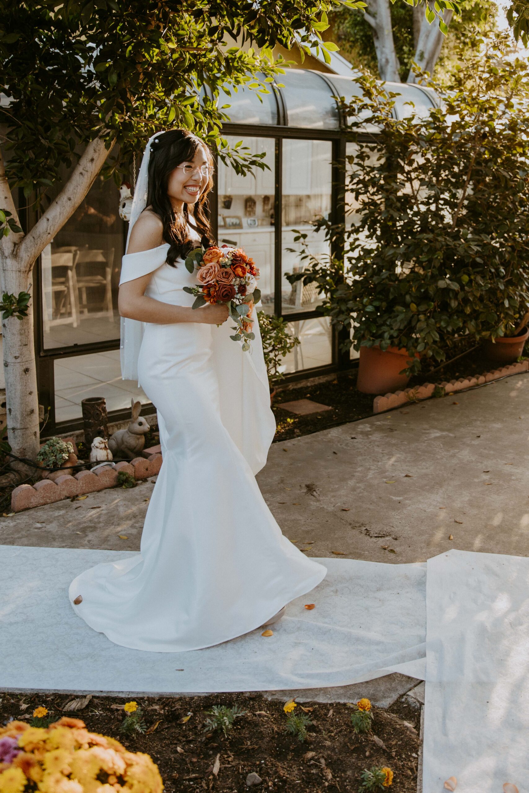 A bride in a white dress holding a bouquet of flowers.
