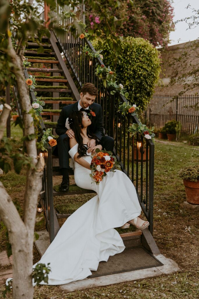 Bride and groom sharing a tender moment on their intimate backyard wedding day.