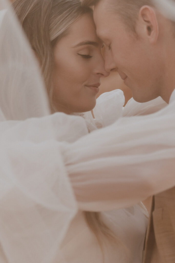 Bride and groom, smiling at each other during their photo shoot