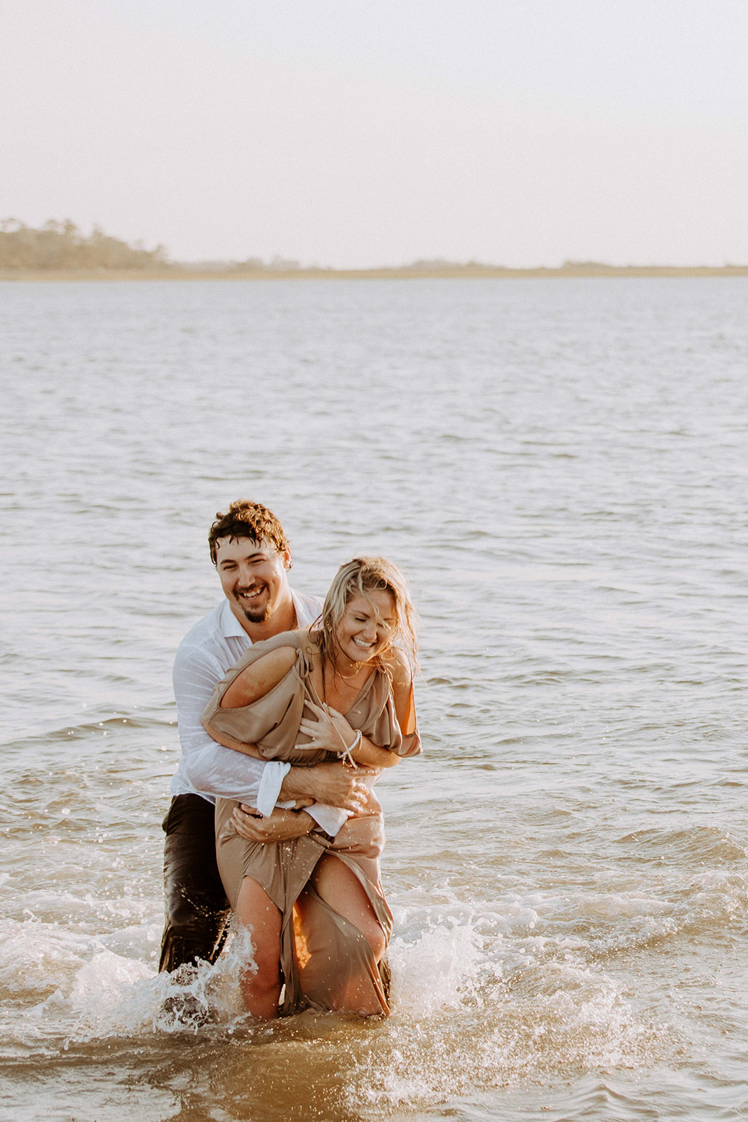 Couple having afun and playful engagement photos session on Tybee island 