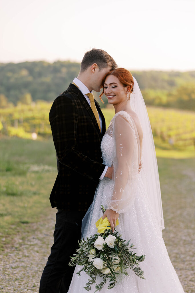 groom kissing the bride on the cheek
