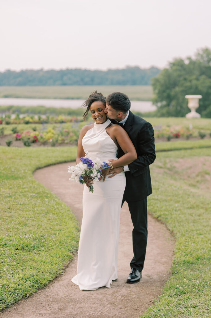 groom kissing the bride on the neck 