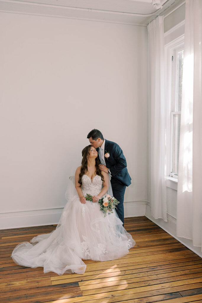 groom kissing the bride on the cheek