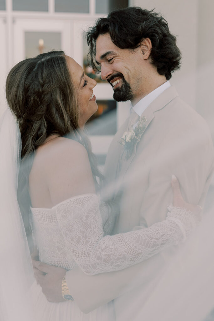 cute picture of the newlyweds smiling at each other