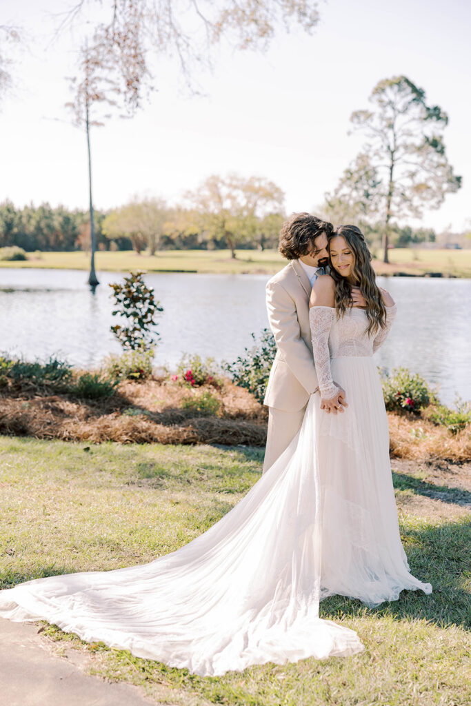 Groom, kissing the bride on the cheek