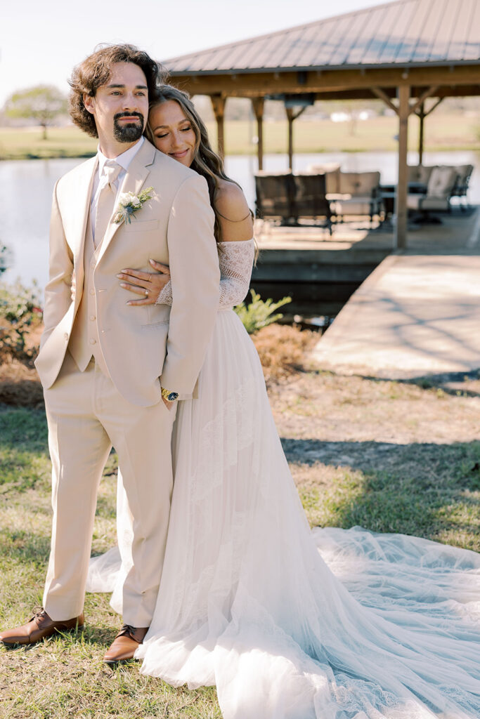 Picture of the bride hugging the groom from the back