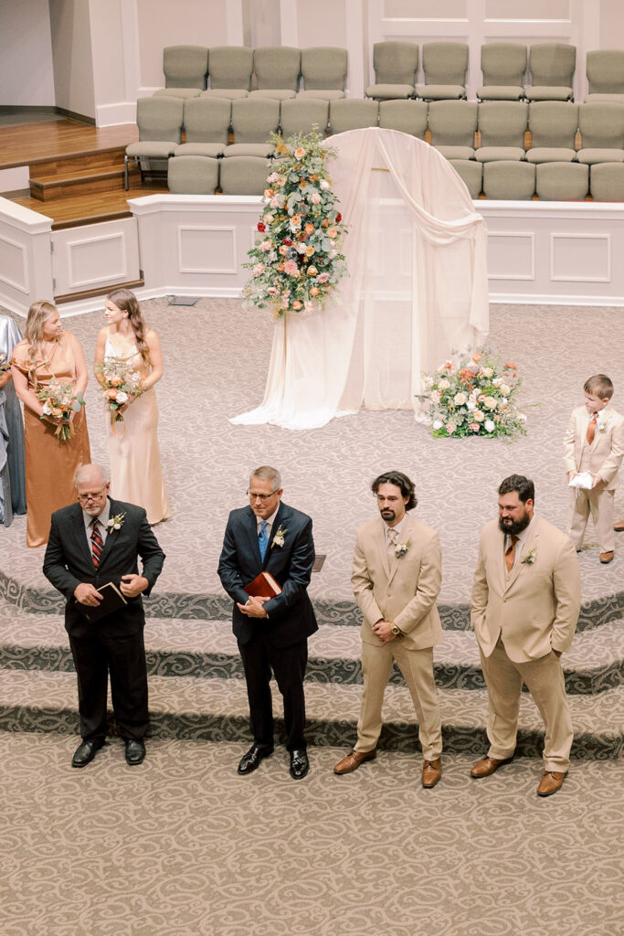 Groom, watching the bride walk down the aisle