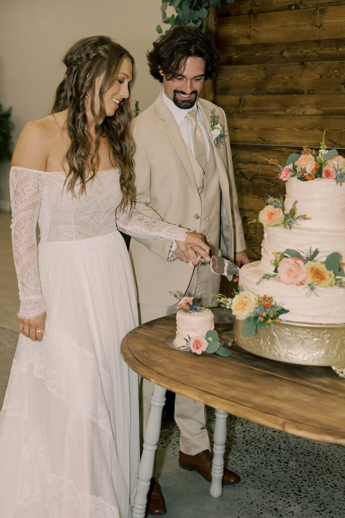 Picture of the newlyweds cutting their wedding cake