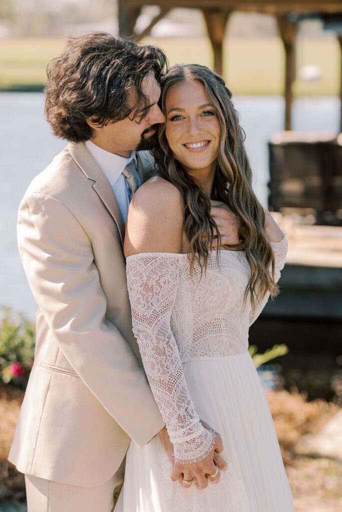 Groom, kissing the bride on the cheek