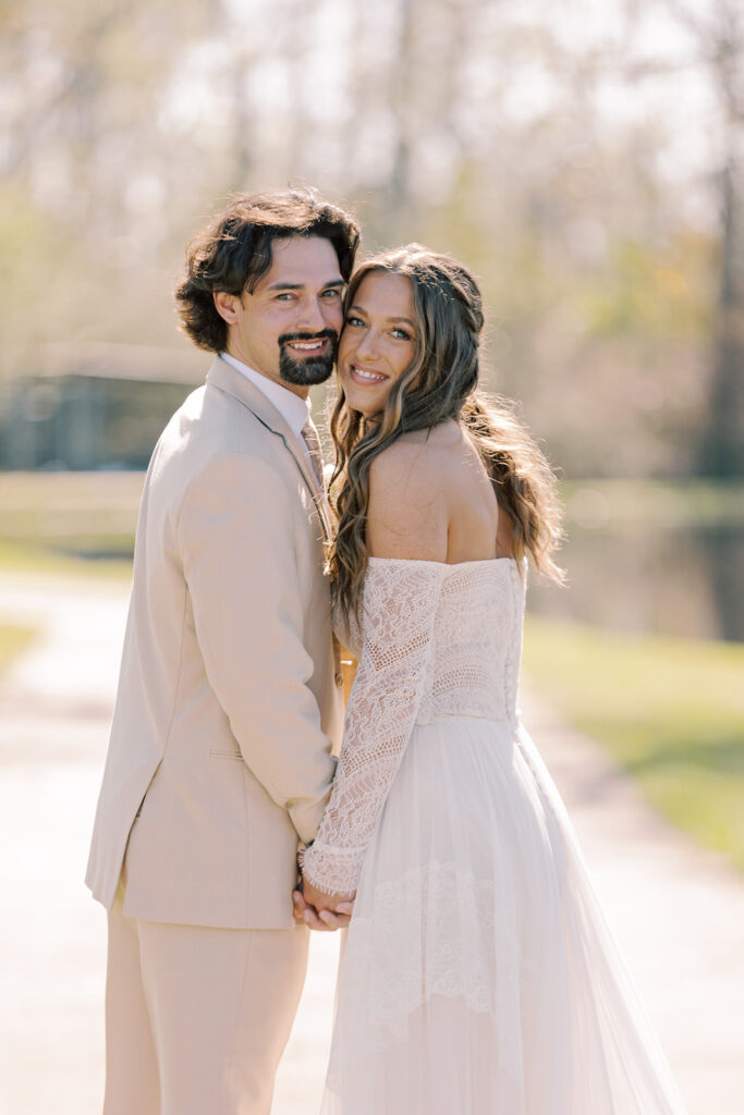 Bride and groom smiling at the camera during their bridal portraits
