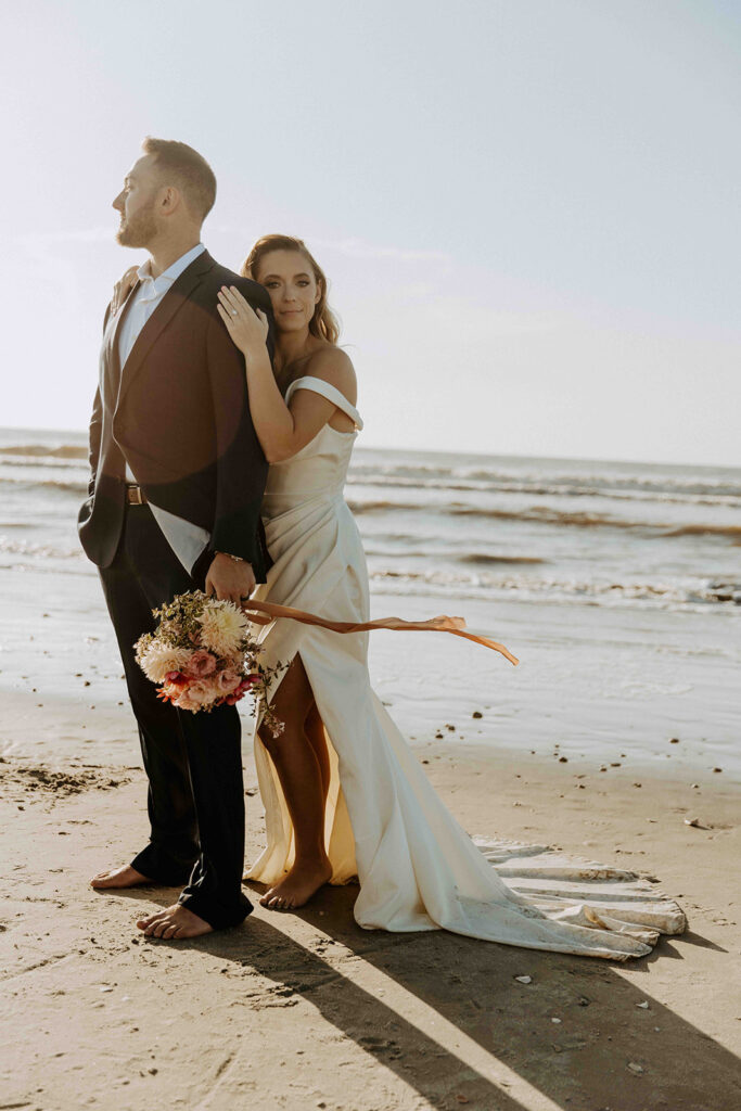 picture of the bride hugging the groom from the back