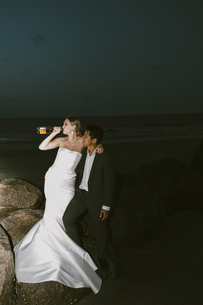 newly married couple celebrating their elopement with champagne