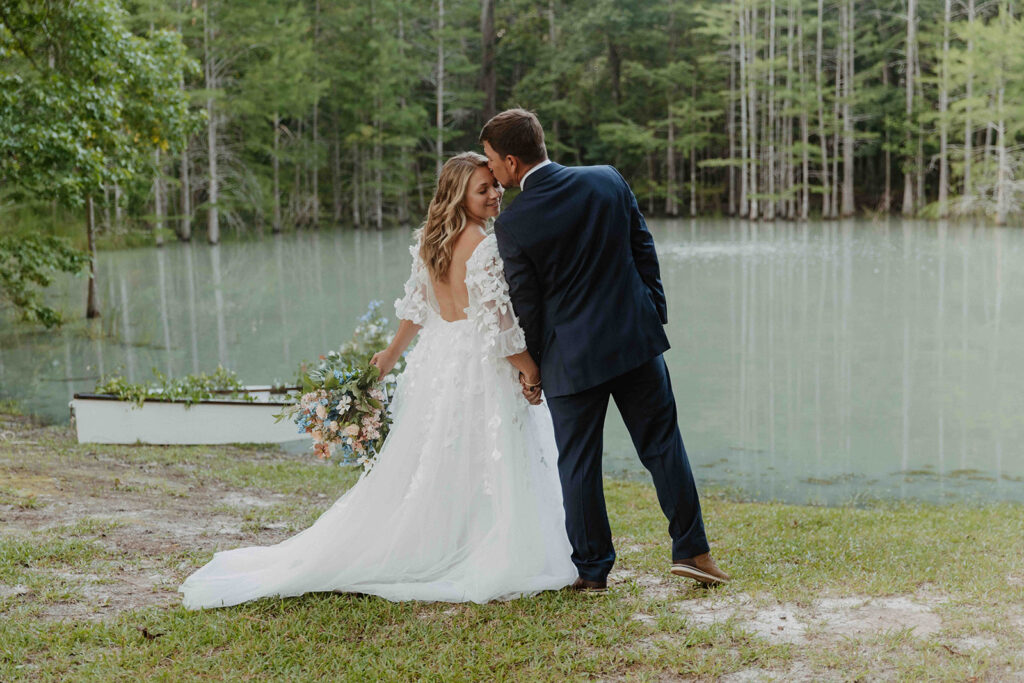 groom kissing the bride on the forehead 
