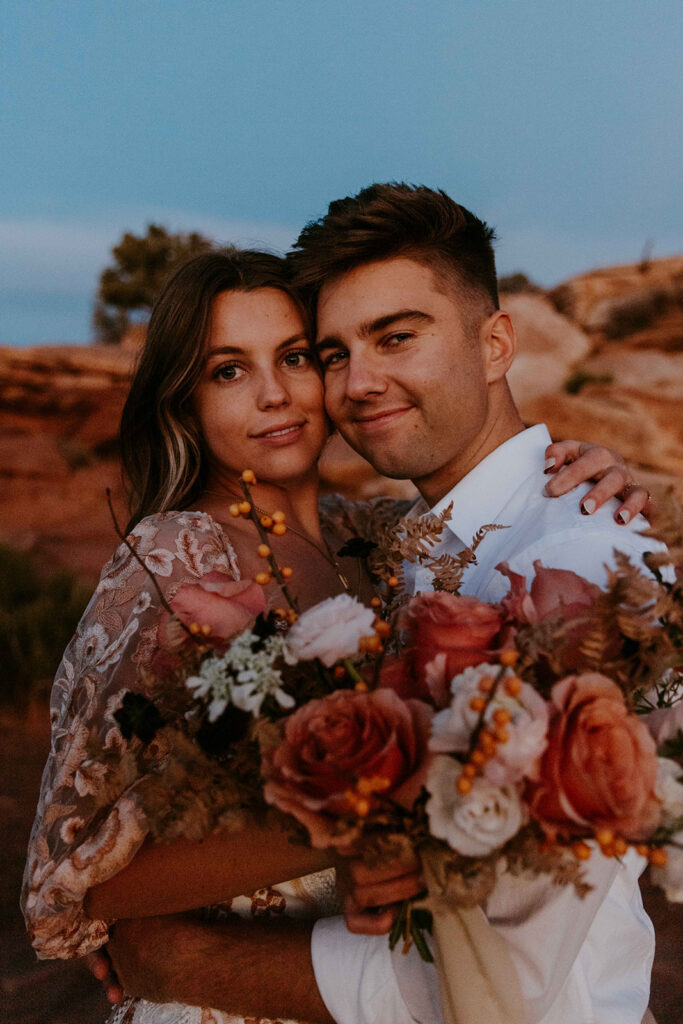 cute couple smiling at the camera during their photoshoot
