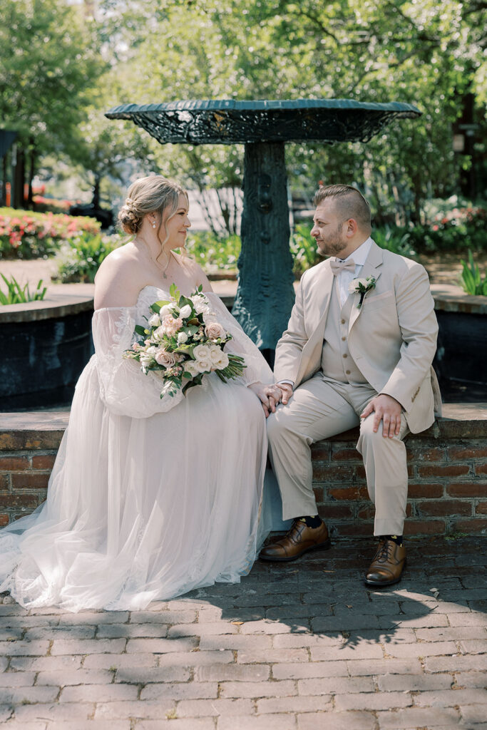 portrait of the bride and groom holding hands