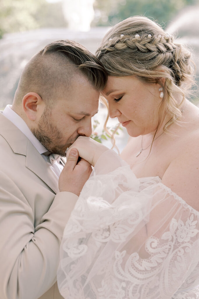 Groom, kissing the brides hand