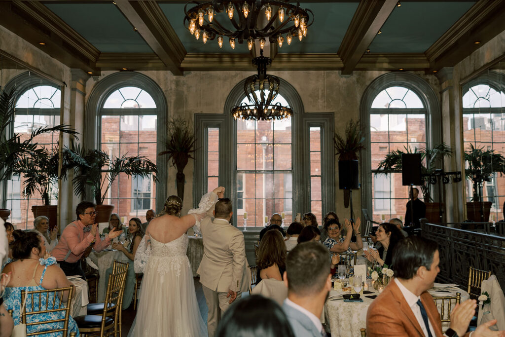 Bride and groom entering their reception party