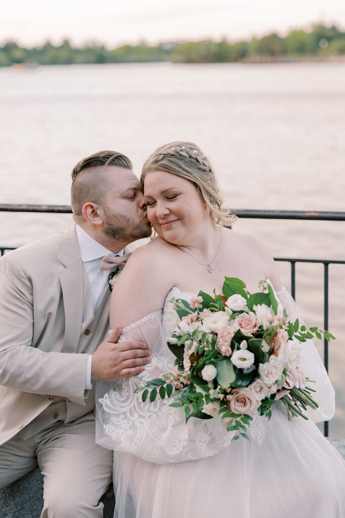 Groom, kissing the bride on the cheek