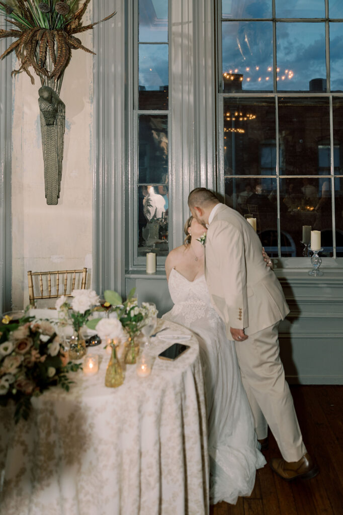 Couple kissing at their reception party