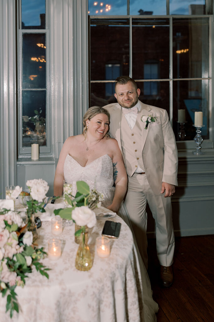 Cute couple smiling at the camera at their reception party