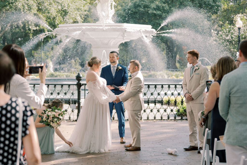 Couple holding hands during their ceremony