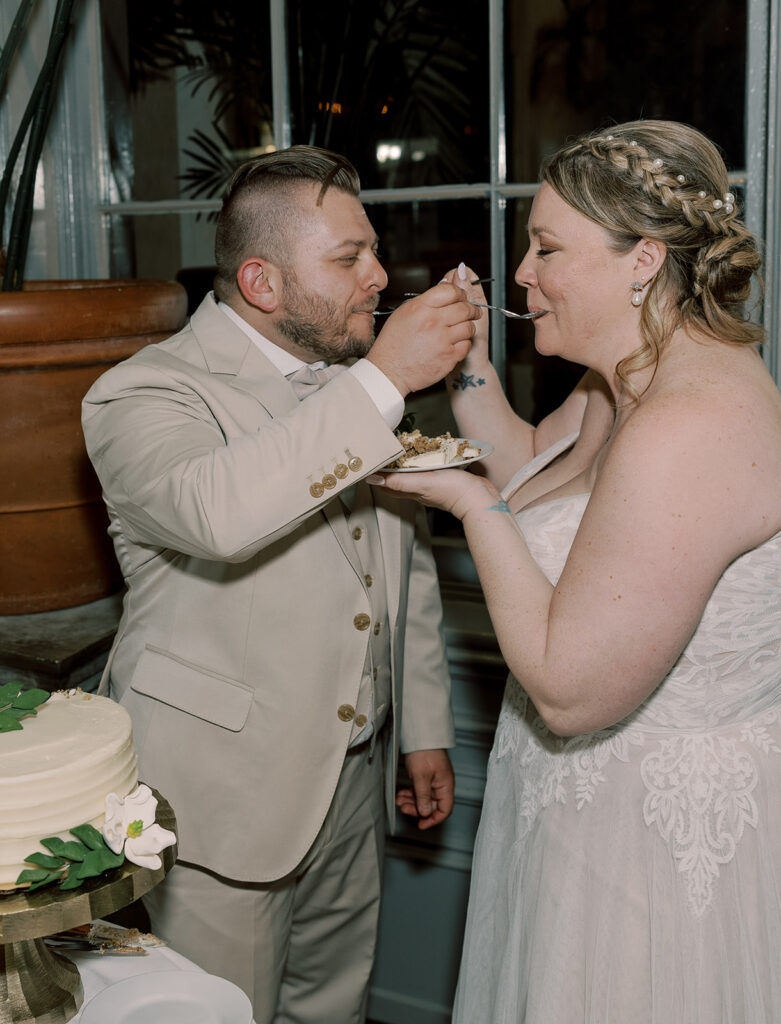 Newly married couple trying their wedding cake