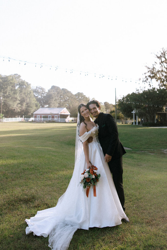 picture of the newlyweds smiling at the camera during their photoshoot