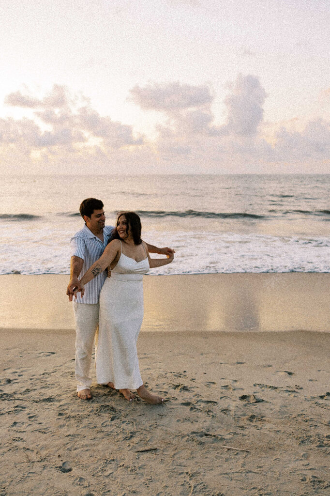 cute couple smiling at each other during their photoshoot