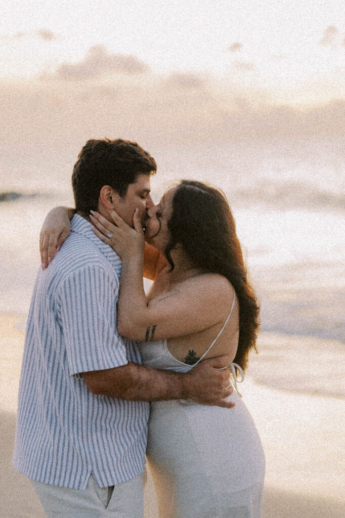 picture of the newly engaged couple kissing