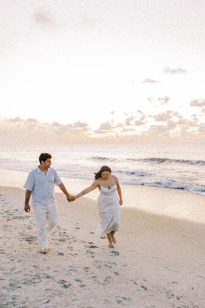 cute couple walking around the beach during their photoshoot