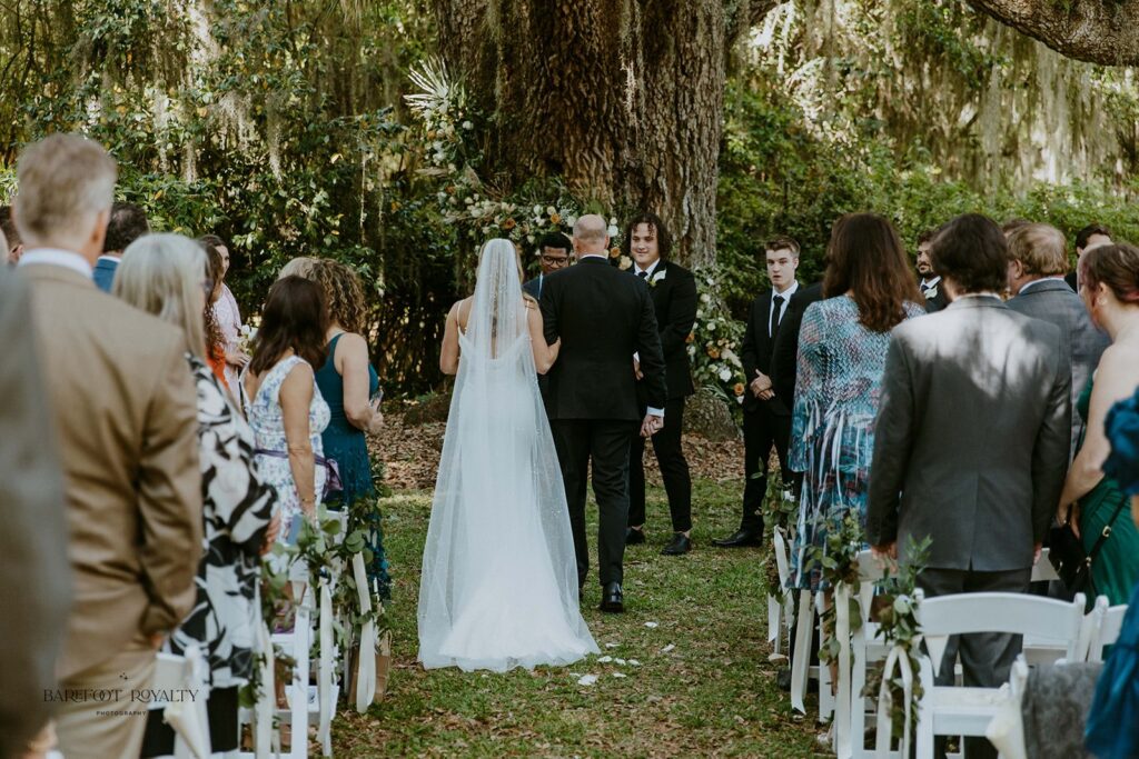 groom watching the bride walk down the aisle 