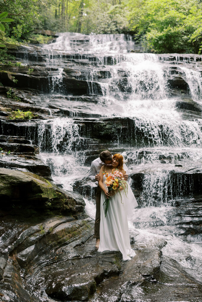 cute portrait of the groom kissing the bride on the cheek