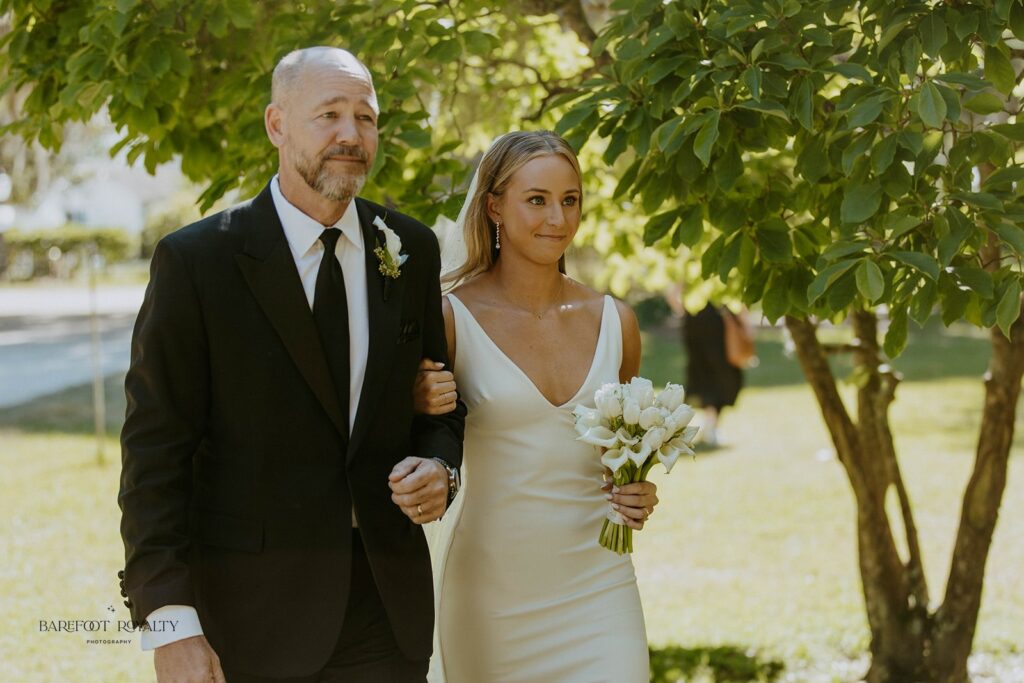 beautiful picture of the bride and her dad walking down the aisle