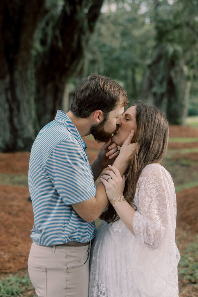 cute picture of the soon to be parents kissing 