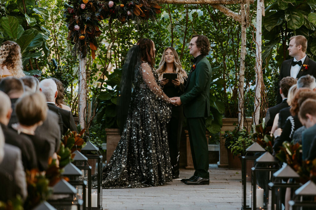 Bride and groom holding hands at the ceremony