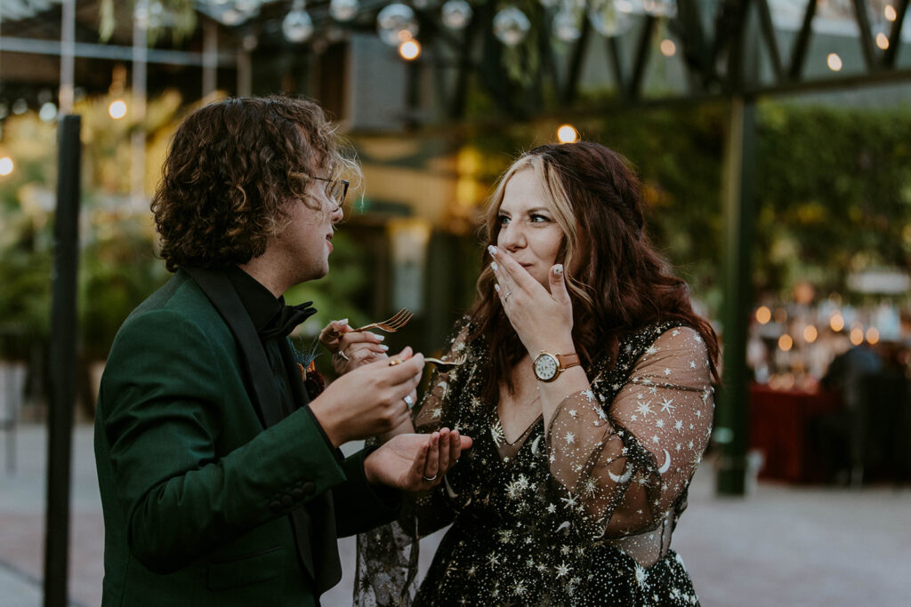 picture of the newlyweds trying their wedding cake