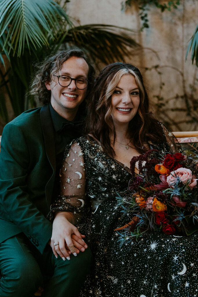 newlyweds smiling at the camera during their bridal portraits