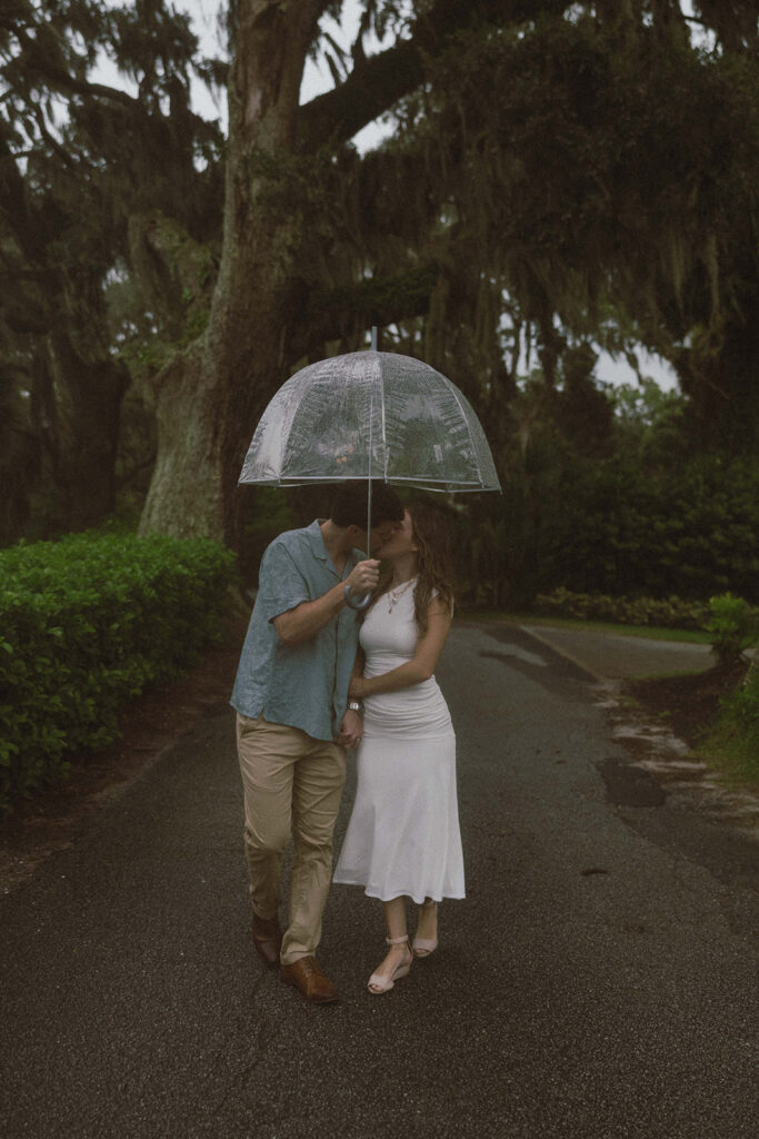 Picture of the newly engaged couple kissing