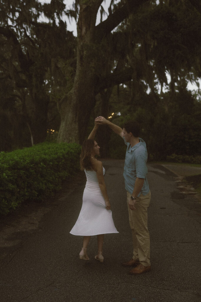 Cute picture of the newly engaged couple dancing during their session