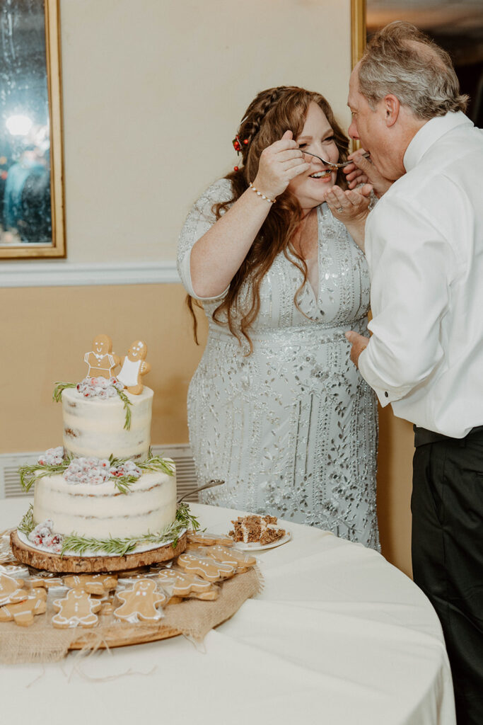 newlyweds trying their wedding cake