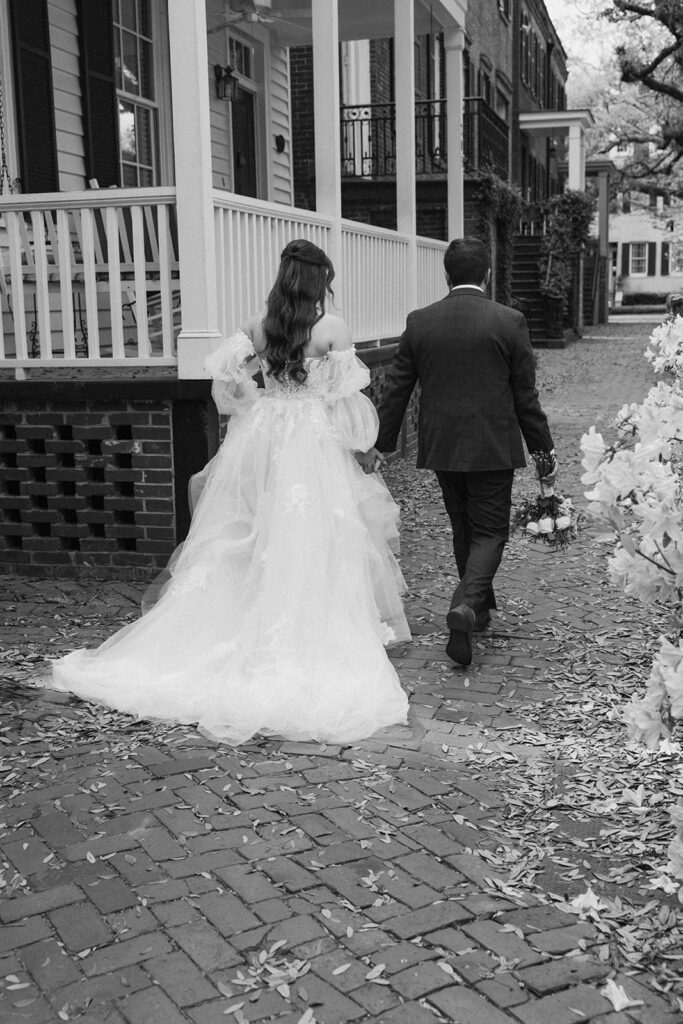 cute picture of the bride and groom holding hands