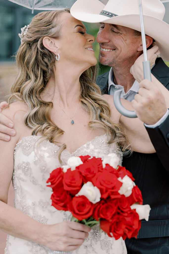 cute portrait of the bride and groom smiling at each other