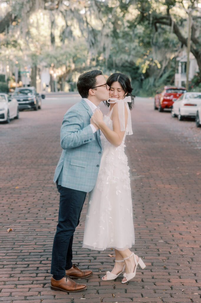 fiance kissing his fiance on the cheek