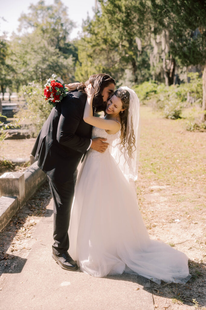Groom, kissing the bride on the cheek