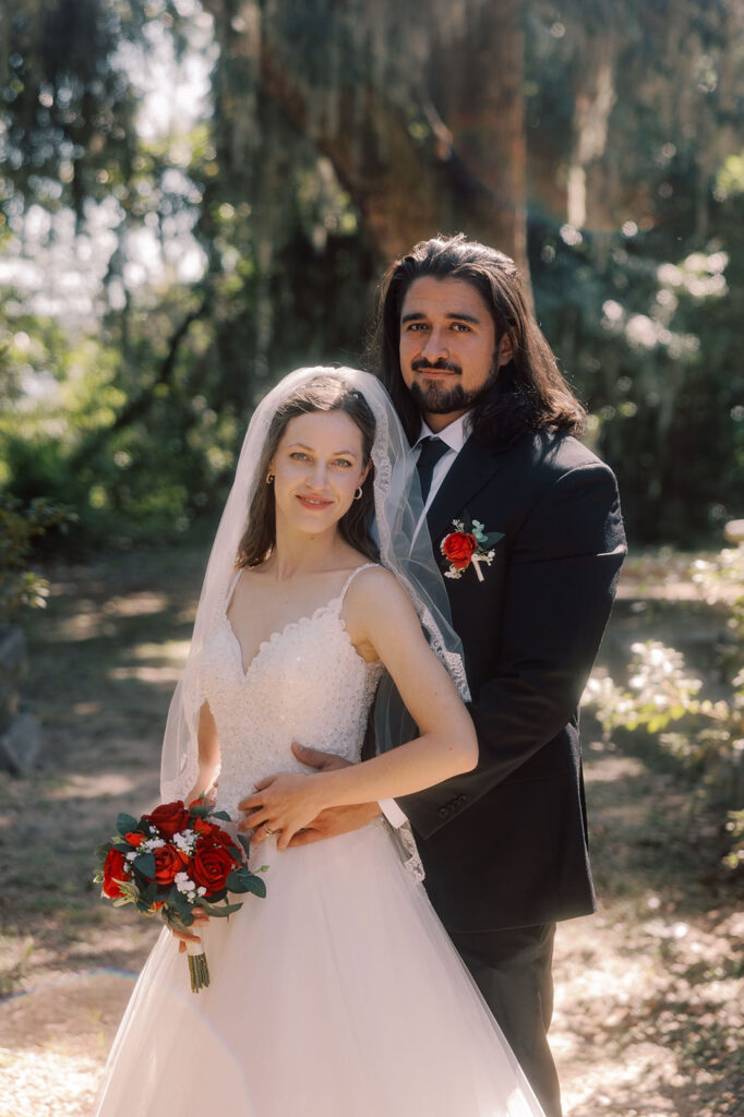 Bride and groom, smiling at the camera during their bridal photos