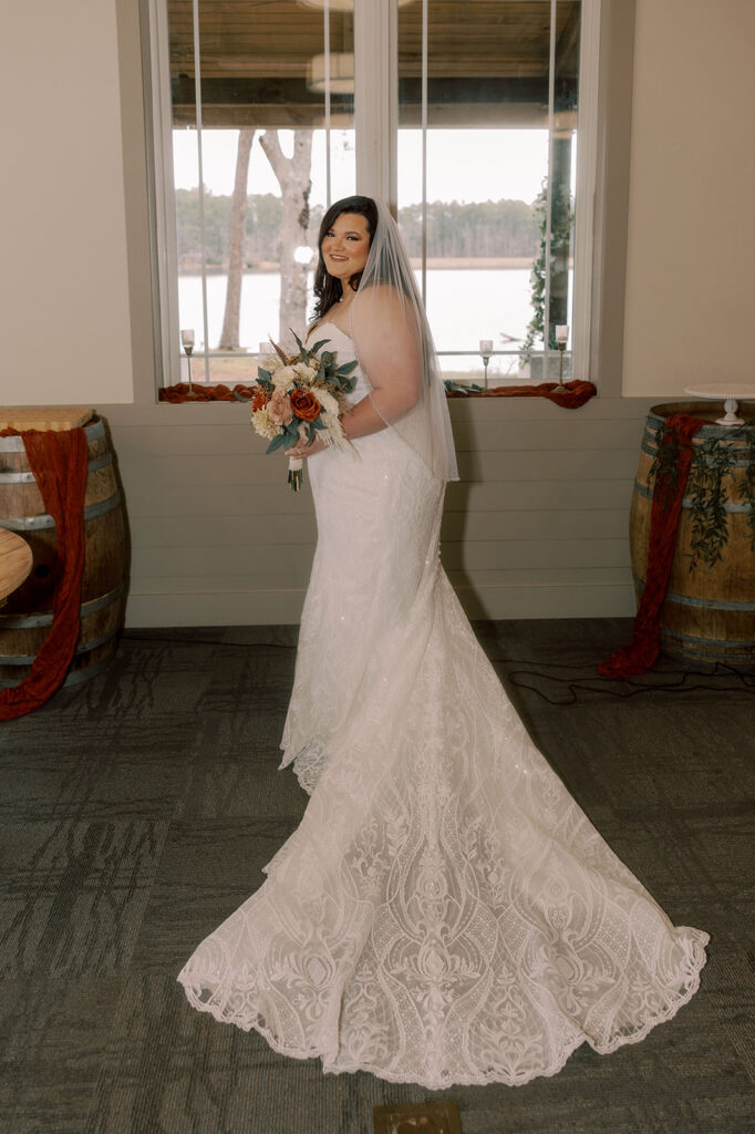 mother of the bride helping her with her wedding dress