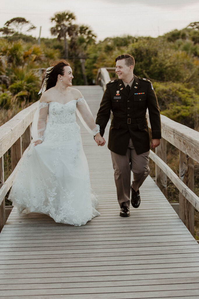 Couple walking around the beach during their bridal photos